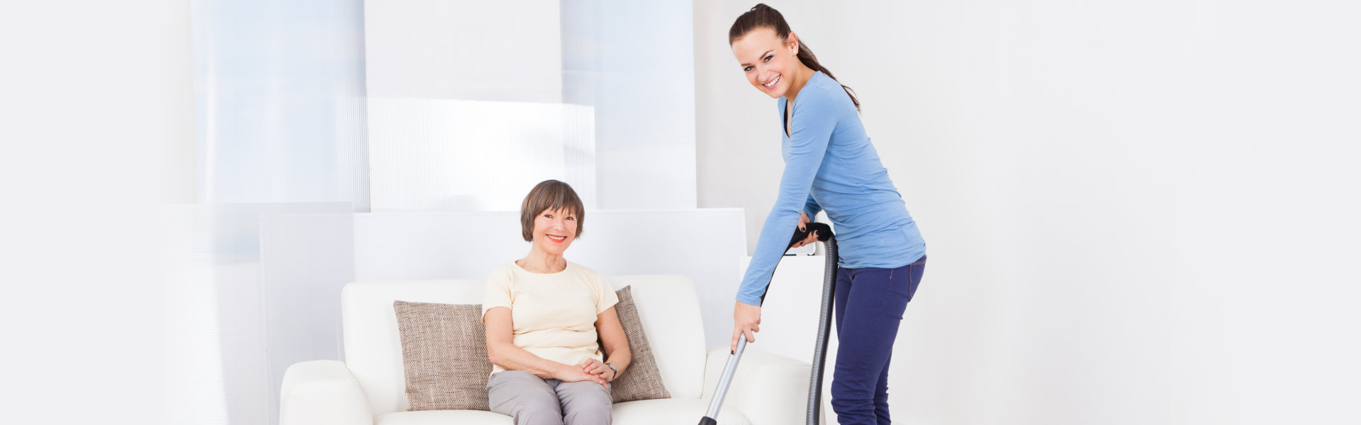 Person cleaning and the other person sitting on a couch