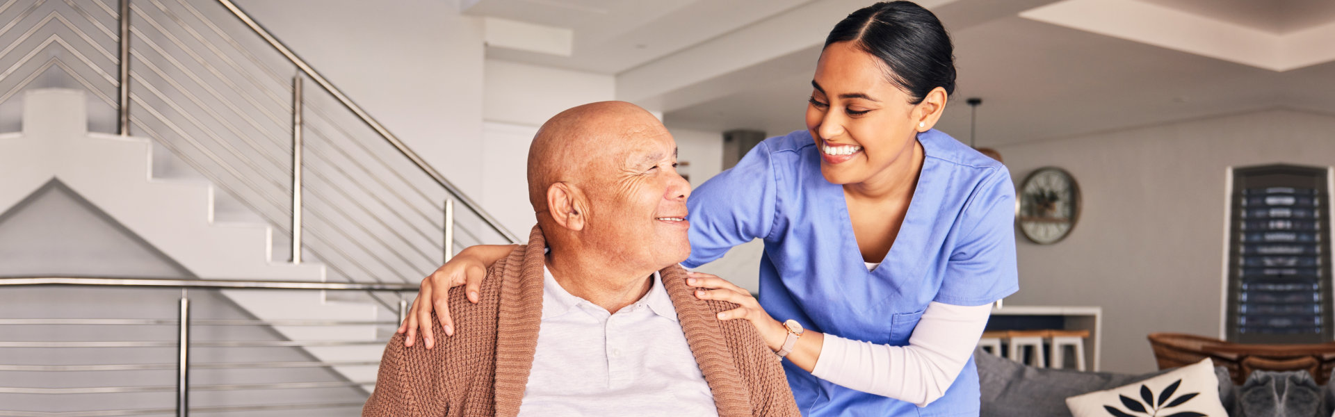 caregiver and elderly man smiling